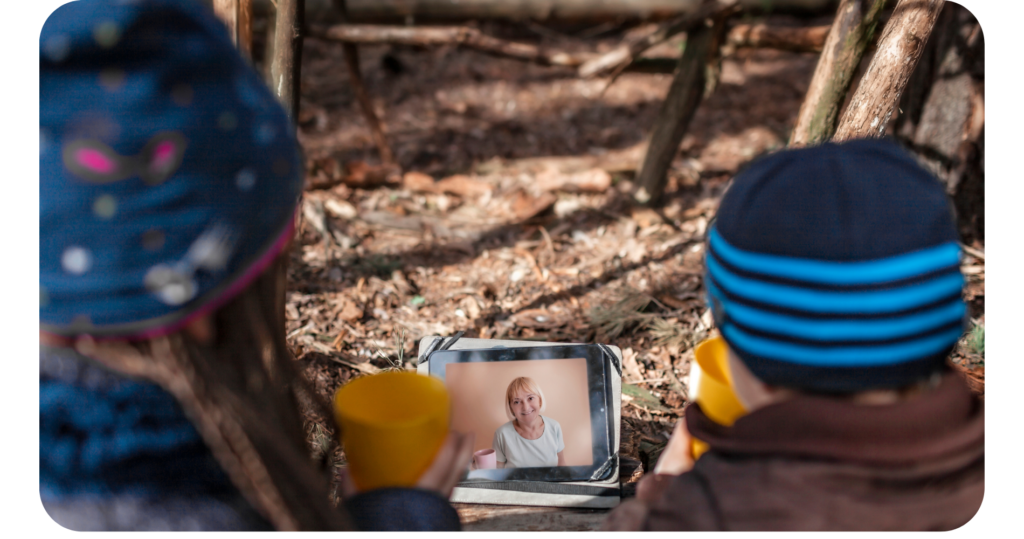 Multilingual children talk to family on a video call outside